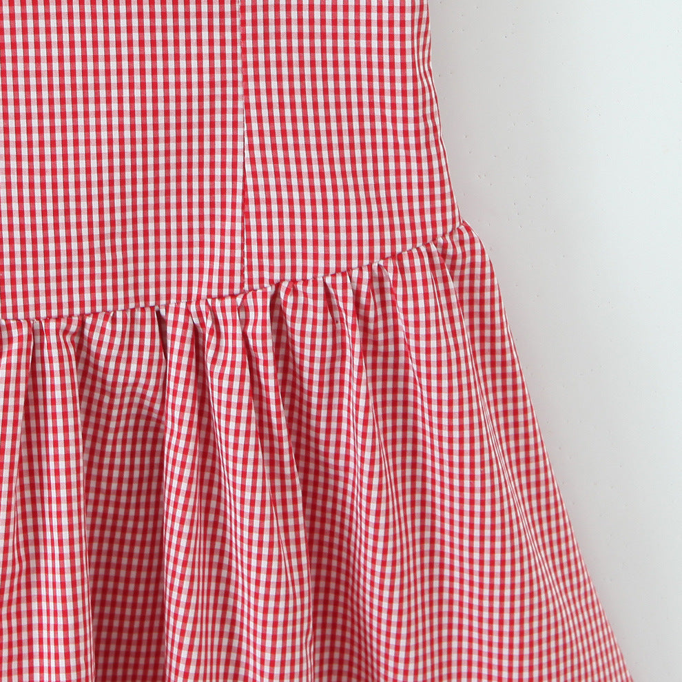 Woman wearing Red Plaid Halter Neck Sleeveless Short Dress in a sunny garden