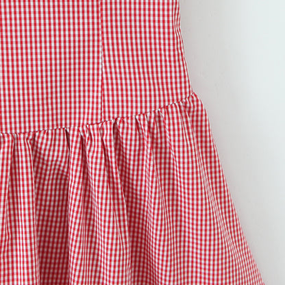 Woman wearing Red Plaid Halter Neck Sleeveless Short Dress in a sunny garden