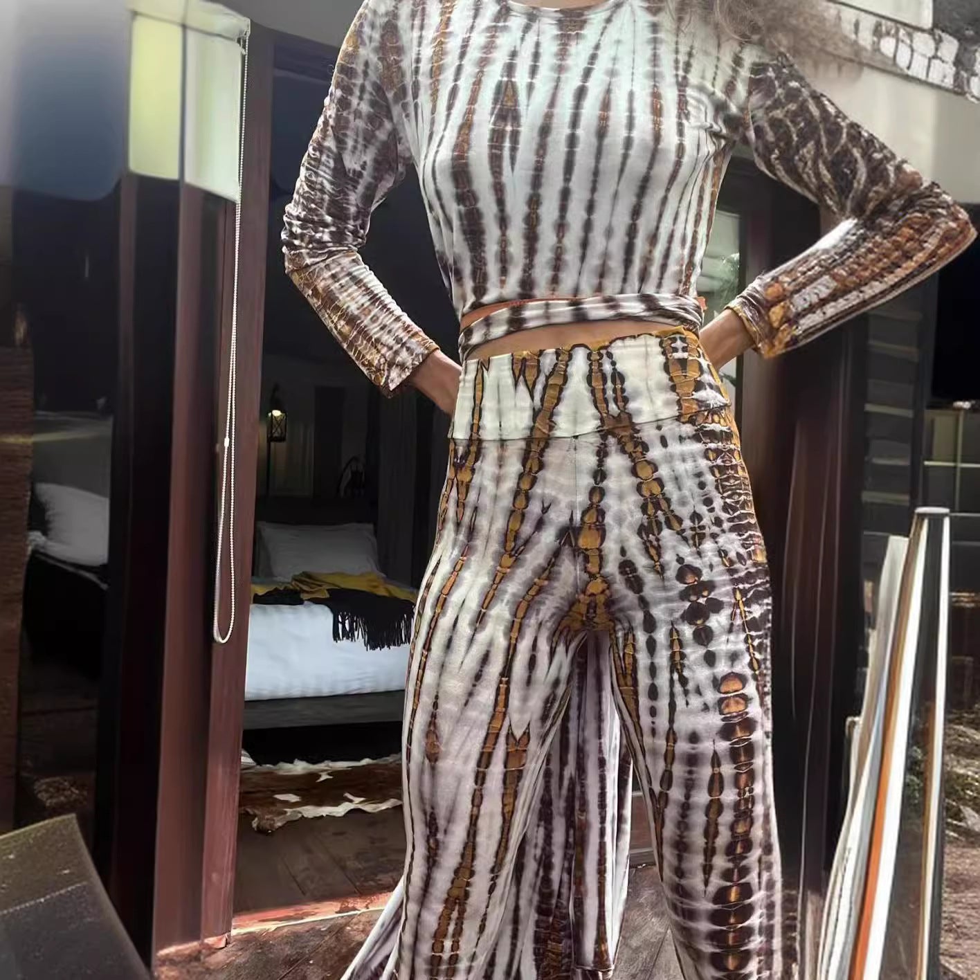Woman wearing Burnout Print Slim Fit High-Waist Trousers in a chic urban setting