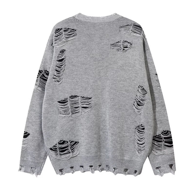Woman wearing Ripped Chain Splicing Loose Knit Sweater in an urban setting