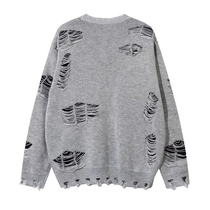 Woman wearing Ripped Chain Splicing Loose Knit Sweater in an urban setting