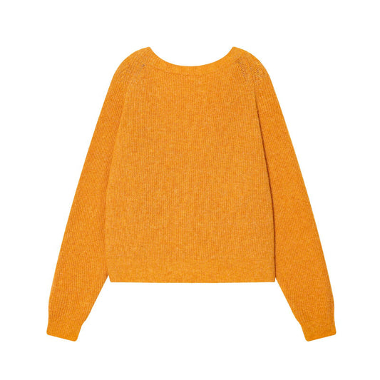 Woman wearing Back Knot Knit Sweater in a cozy setting