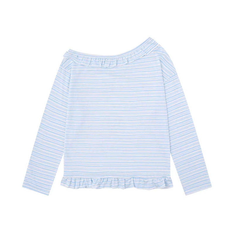Woman wearing Anime Print Asymmetric Neck Long Sleeve Top in a casual outdoor setting