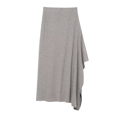 Woman wearing Asymmetric Pleated Midi Skirt in a stylish setting