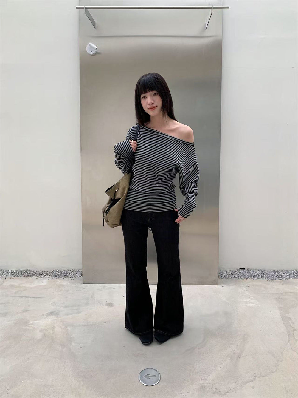 Woman wearing Retro Double Buckle Flared Jeans in a urban street setting