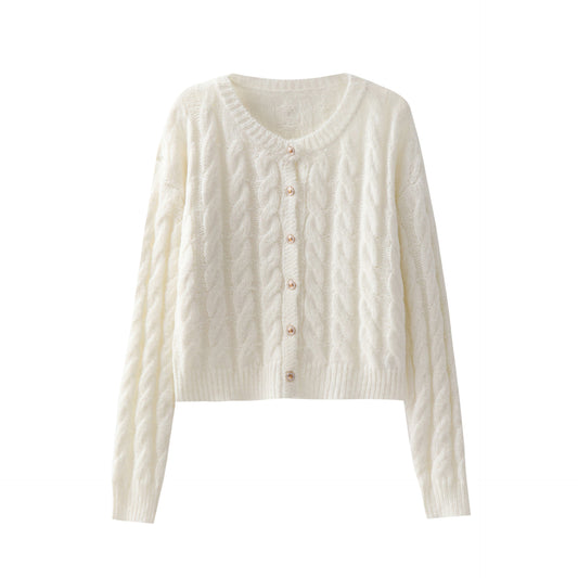 Woman wearing cable knit round neck sweater in a cozy setting