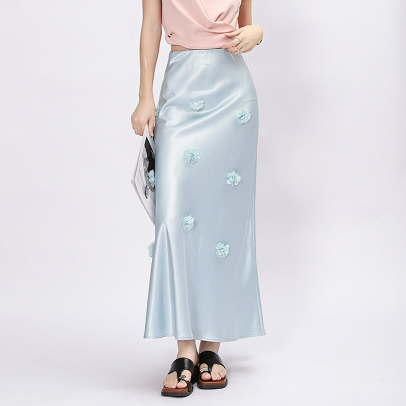 Woman wearing 3D floral skirt in a garden setting