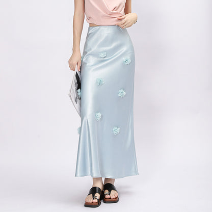 Woman wearing 3D floral skirt in a garden setting