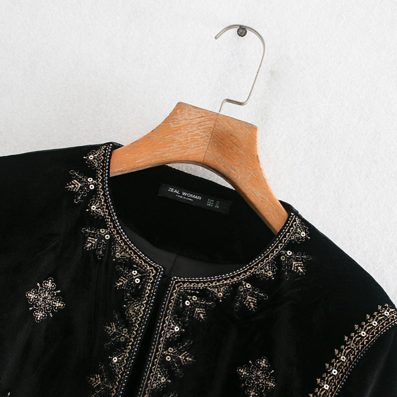Woman wearing Royal Embroidered Velvet Coat in an elegant setting