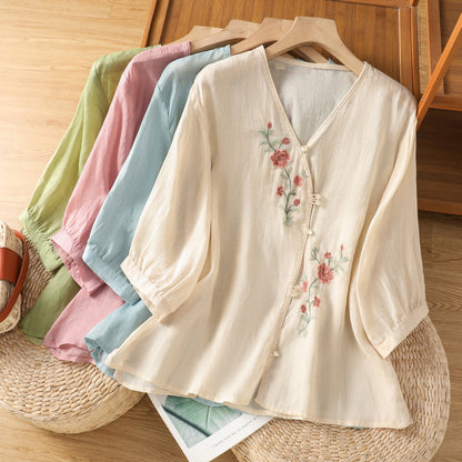 Woman wearing embroidered shirt top in a casual outdoor setting