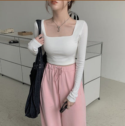 Woman wearing Slim Fit Long Sleeve Square Neck Top in a stylish setting