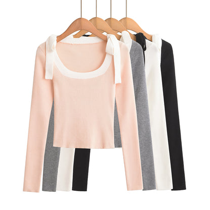 Woman wearing Square Neck Bow Ribbon Slim Fit Long Sleeve Sweater in a chic urban setting