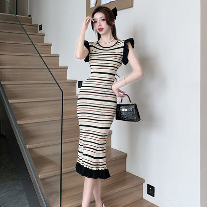 Woman wearing Women’s Striped Knitwear Dress in a sunny outdoor setting
