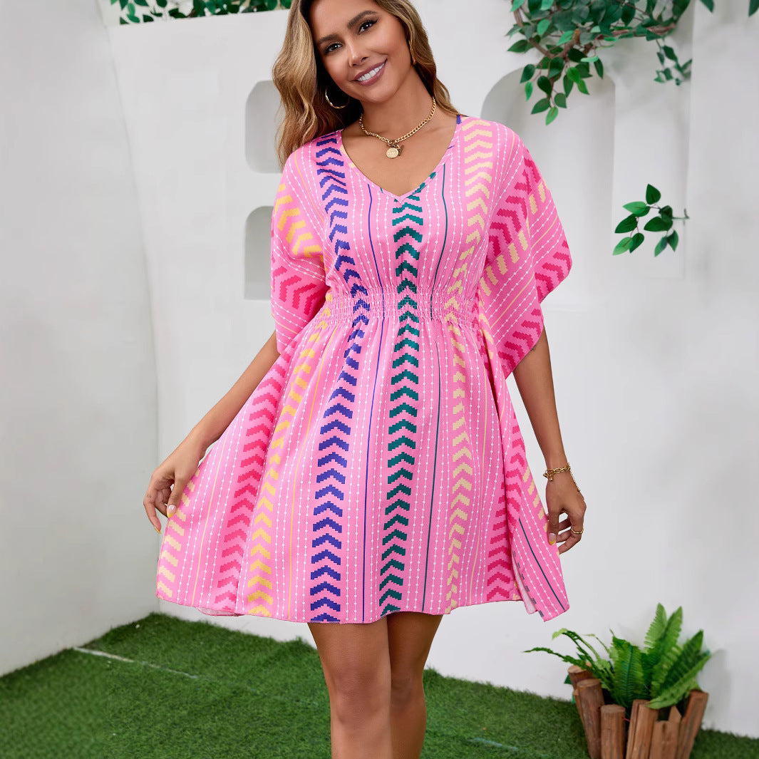 Woman wearing Bohemian Floral V-Neck Mini Dress in a sunny beach setting