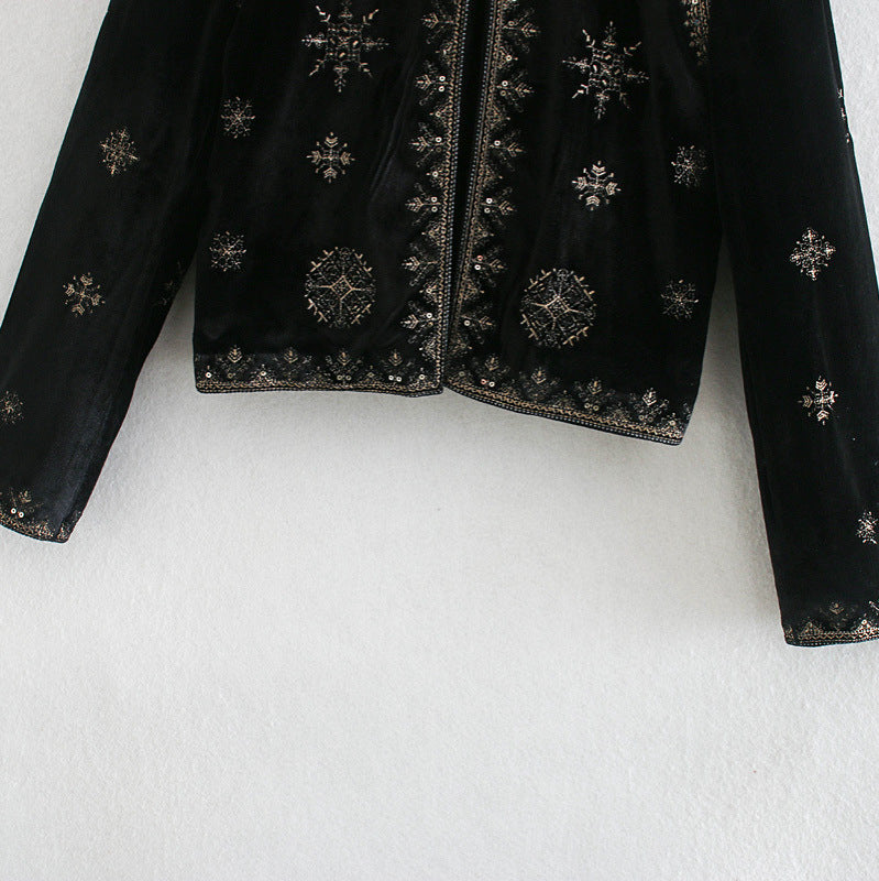 Woman wearing Royal Embroidered Velvet Coat in an elegant setting