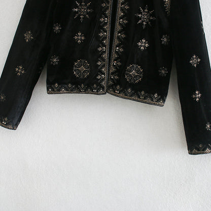 Woman wearing Royal Embroidered Velvet Coat in an elegant setting