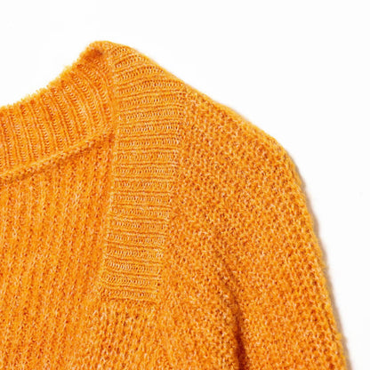 Woman wearing Back Knot Knit Sweater in a cozy setting