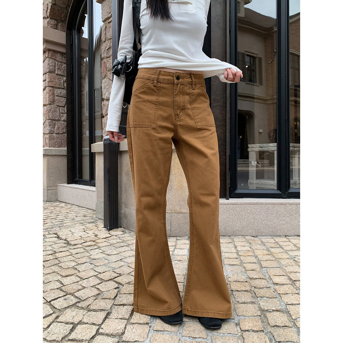 Woman wearing Distressed Flared Jeans with Pockets in a casual setting