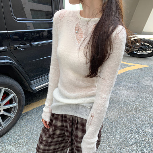 Woman wearing Irregular Cut-Out Long Sleeve Knit Top in a stylish setting