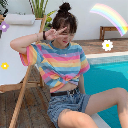 Woman wearing Rainbow Stripe Loose T Shirt in a sunny outdoor setting