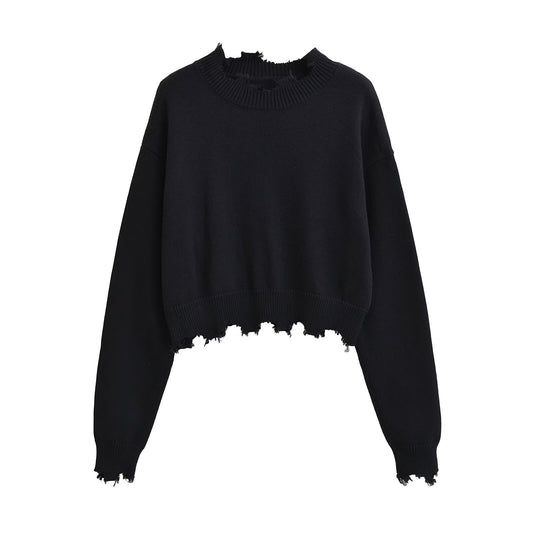 Woman wearing Loose Fit Round Neck Long Sleeve Sweater in a cozy setting