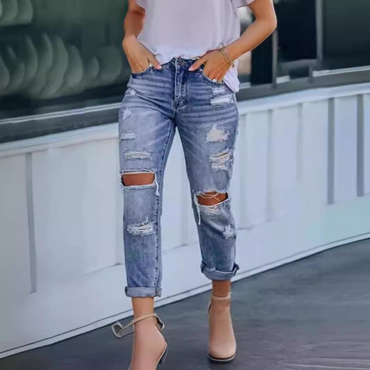 Woman wearing Ripped Mid Waist Jeans in a casual outdoor setting