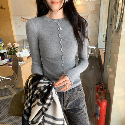 Woman wearing Lace Trim Round Neck Long Sleeve Knit Top in a stylish setting