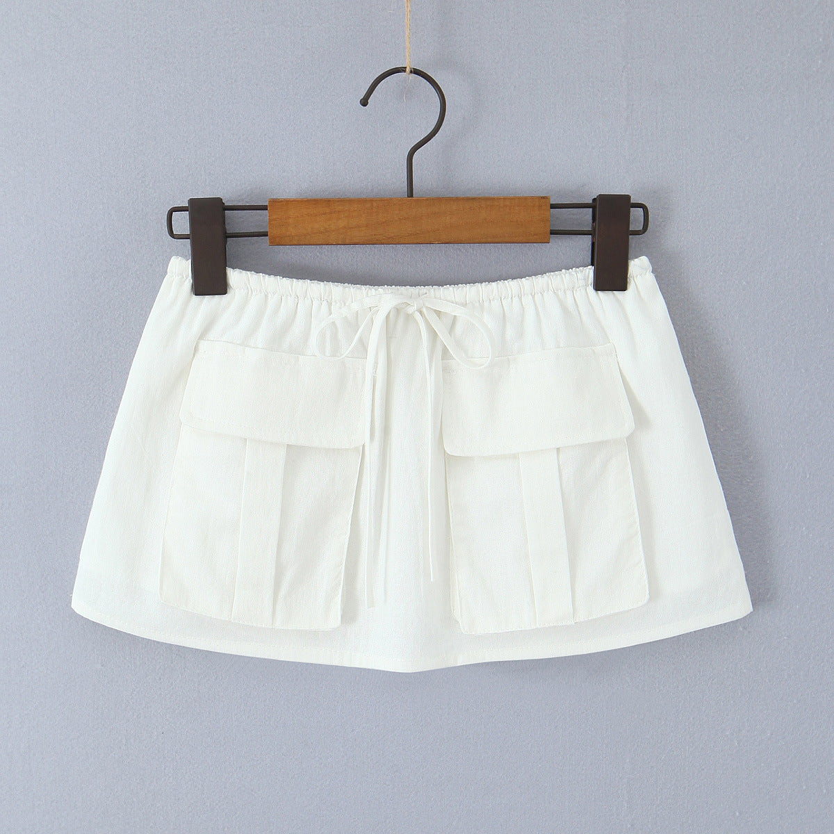 Woman wearing One Shoulder Tie Up Top and Pocket Detailed Skirt Set in a sunny outdoor setting