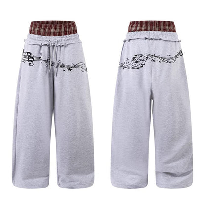 Woman wearing Double Waistband Music Note Graffiti Wide Leg Pants in a casual setting