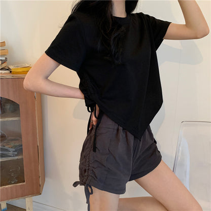 Woman wearing Irregular Drawstring Cropped T-Shirt in a city setting