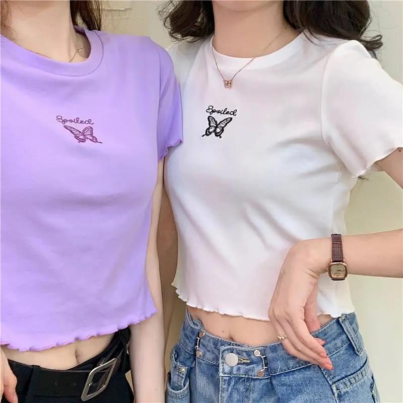 Woman wearing Butterfly Embroidered Crop Top in a sunny park