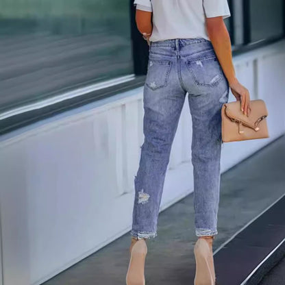 Woman wearing Ripped Mid Waist Jeans in a casual outdoor setting