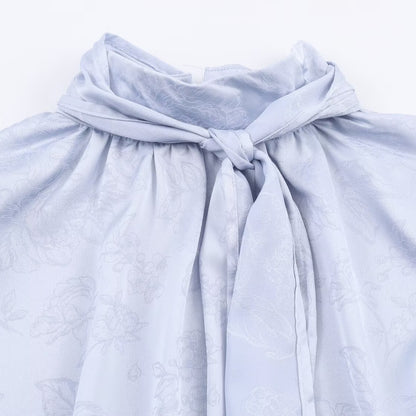 Woman wearing Embroidered Satin Bow Detail Blouse in a chic setting