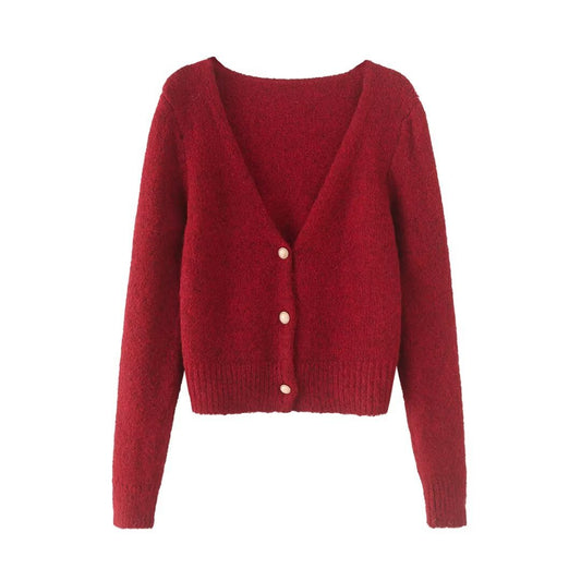 Woman wearing V-Neck Long Sleeve Sweater in a cozy setting