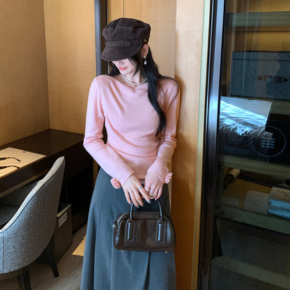 Woman wearing Boat Neck Long Sleeve Slim Fit Knit Top in a stylish setting