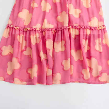 Woman wearing Floral Resort Style Square Neck Strap Dress in a sunny beach setting