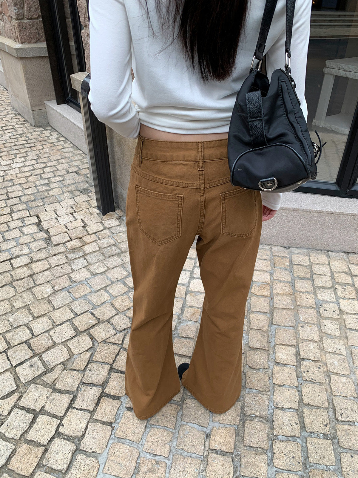 Woman wearing Distressed Flared Jeans with Pockets in a casual setting