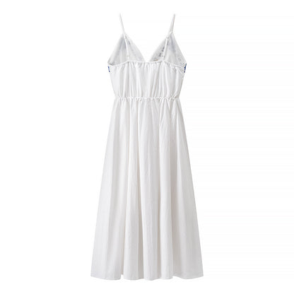 Woman wearing Embroidered Strapless Midi Dress in a sunny garden