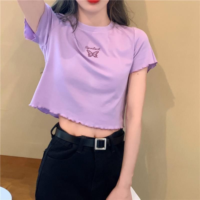 Woman wearing Butterfly Embroidered Crop Top in a sunny park