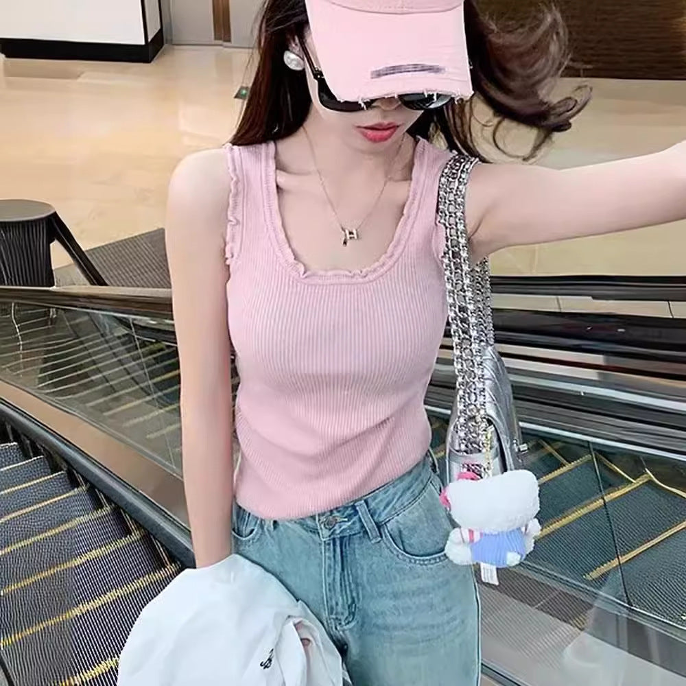 Woman wearing knitted vest in a stylish urban setting