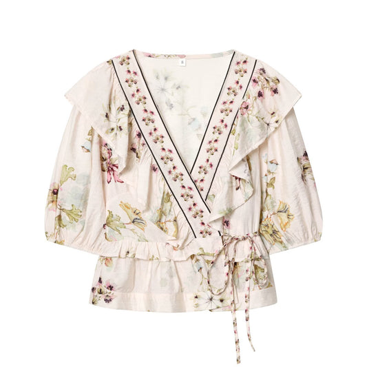 Woman wearing Floral Pattern V Neck Asymmetric Hem Top in a stylish setting