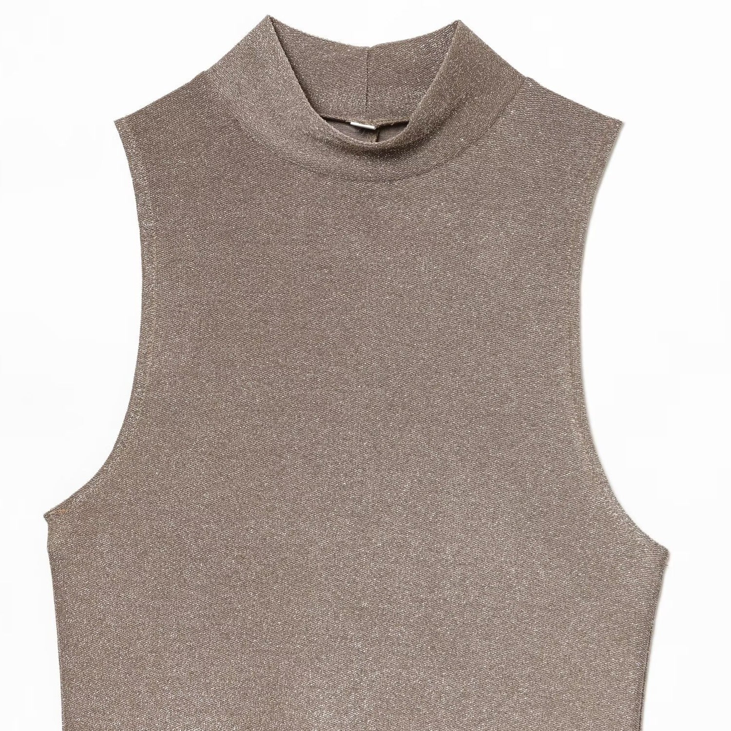 Woman wearing metallic sleeveless dress in a casual setting