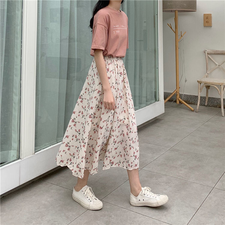 Woman wearing Floral Bohemian A-Line Midi Skirt in a sunny park