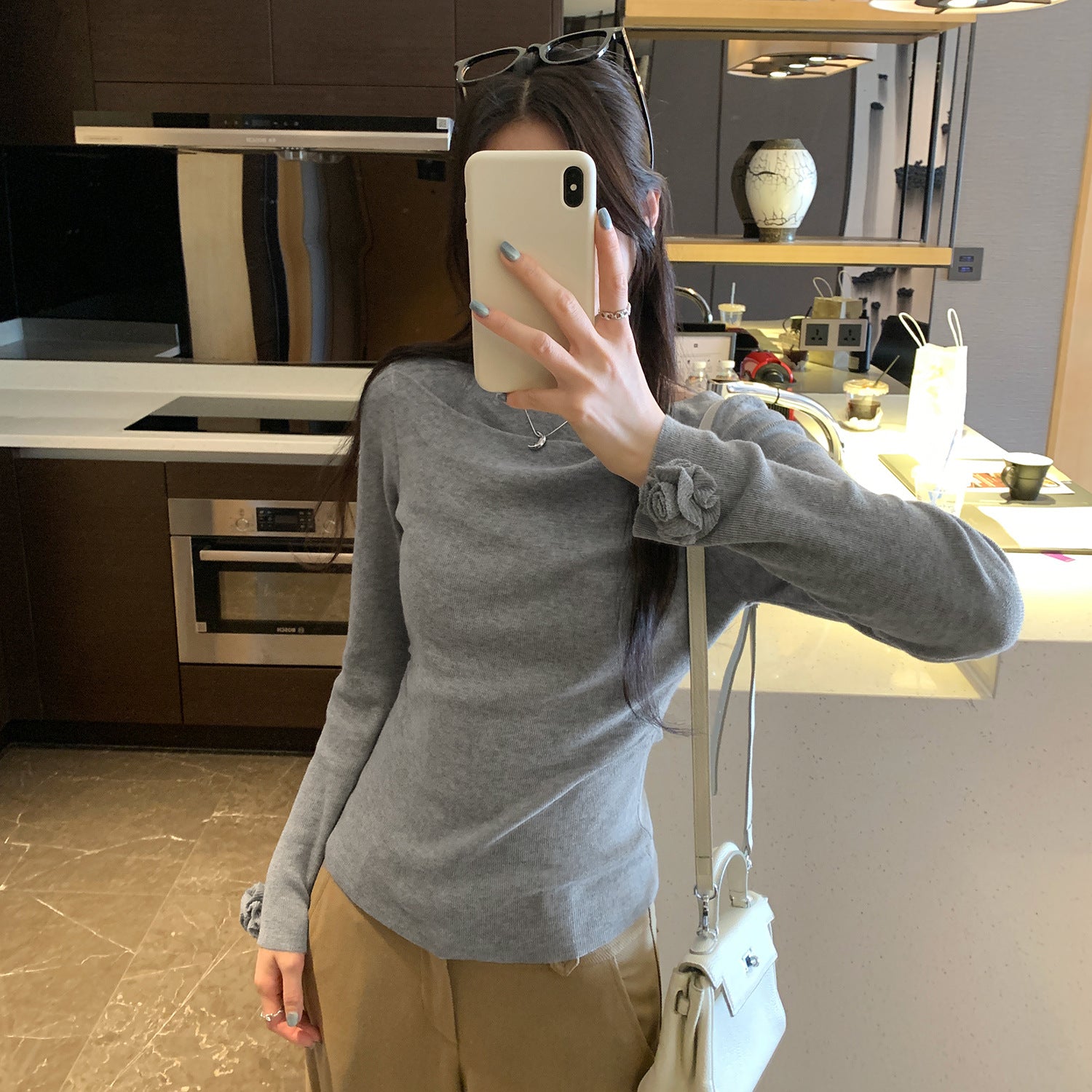 Woman wearing Boat Neck Long Sleeve Slim Fit Knit Top in a stylish setting