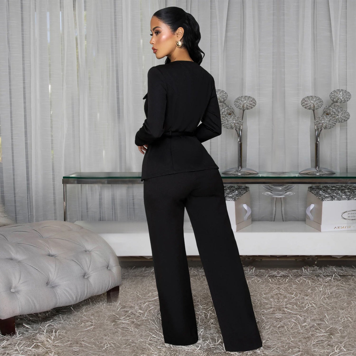 Woman wearing Slimming Belted Long Sleeve Top and Pants Set in a stylish urban setting