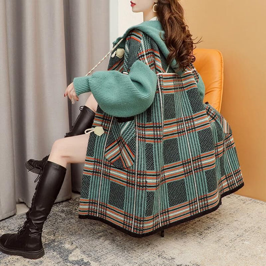 Woman wearing Hooded Oversized Knitted Cardigan in a cozy autumn setting