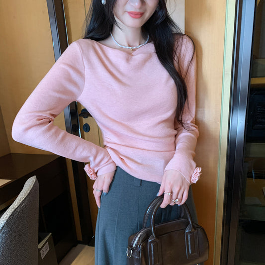 Woman wearing Boat Neck Long Sleeve Slim Fit Knit Top in a stylish setting