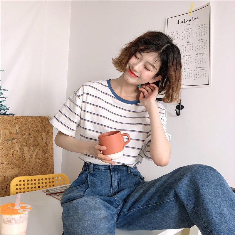 Woman wearing Academy Style Loose Fit Striped T-Shirt in a casual setting