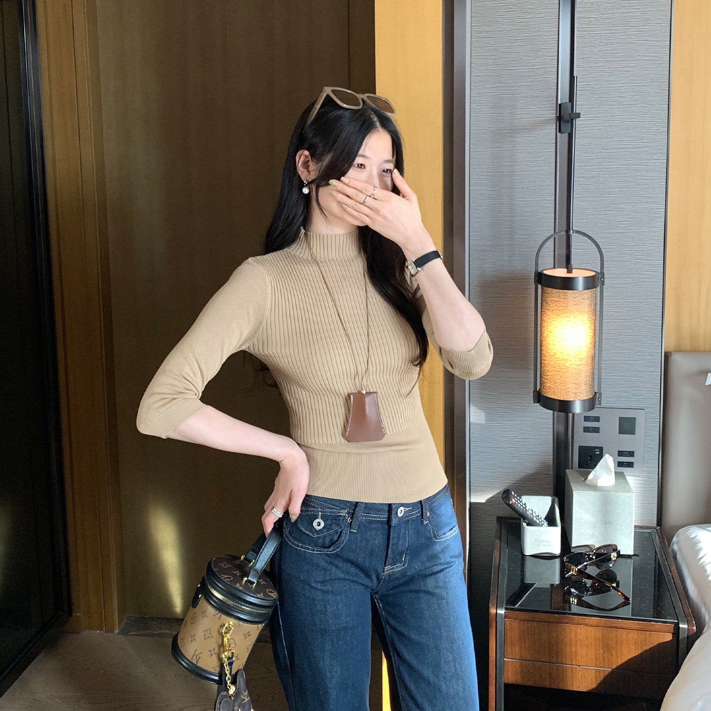 Woman wearing Half-High Neck Slim Fit Knit Top in a stylish setting