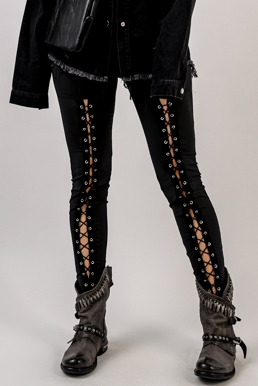 Woman wearing Black Grommet Lace Up Front Leggings in a stylish setting